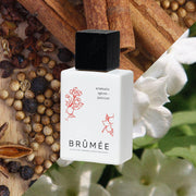 Aromatic Spices + Jasmine Alcohol-free Fine Fragrance in front of flowery background | Brûmée - Kind to Skin Fragrance